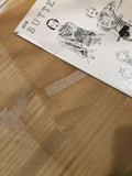 showing pattern piece repair with a brace made from vintage pattern tissue